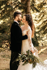 Beautiful couple in love kissing in the forest, forest wedding. Wedding for two.