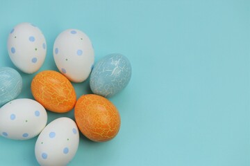 Easter holiday.Multicolored eggs set on a light blue background.Spring festive easter background. copy space.