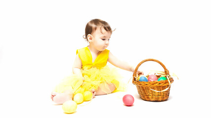 baby with colored eggs on easter holiday on white background