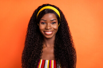 Photo of dark skin happy charming woman beaming smile good mood isolated on orange color background