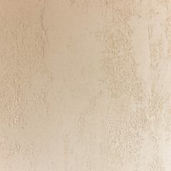 Beige matt plaster wall close up. Decorative Venetian plaster wall