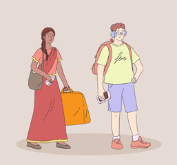 Young guy with backpack, glasses and headphones and Indian girl with luggage and a suitcase stands with boarding pass and waits for her ticket control.