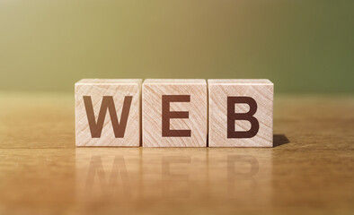 WEB word written on wooden blocks on wooden table. Concept for your design.