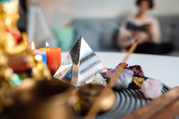 Caucasian girl reading book while sitting on couch at home shrine