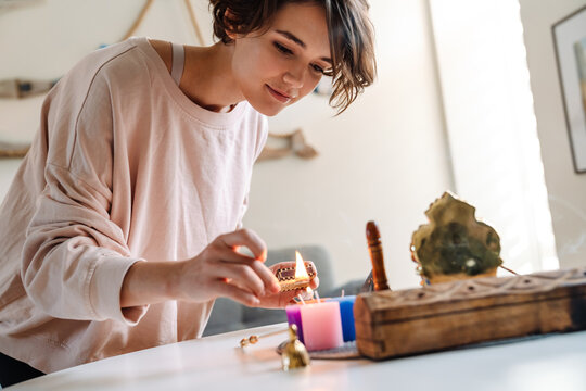 Peaceful Beautiful Girl Lighting Candles At Home Shrine Indoors