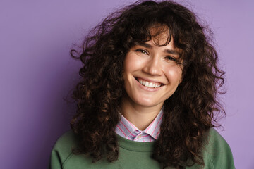 Happy beautiful curly girl smiling and looking at camera