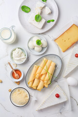 Fresh dairy products on white marble background.