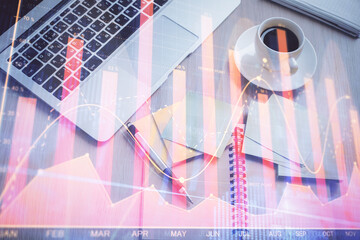 Stock market graph and top view computer on the table background. Double exposure. Concept of financial education.