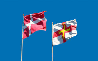 Flags of Guernsey and Denmark.