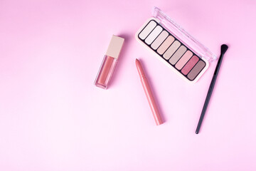 set of decorative make up cosmetics on rose background with copy space