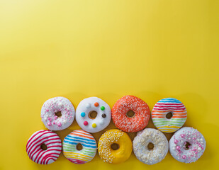 Set of donuts on yellow background.