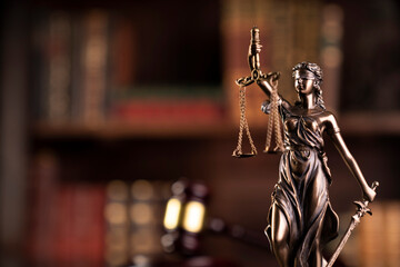 Law theme. Judge chamber. Judge’s gavel, Themis sculpture and collection of legal books on the...
