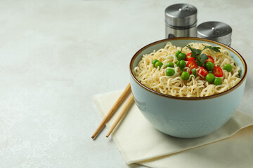 Concept of tasty eating with bowl of noodles on white textured background