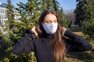 Young woman wears reusable mask outdoors during coronavirus covid-19 pandemic