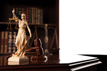Law theme. Judge chamber. Judge’s gavel, Themis sculpture and collection of legal books on the brown background.