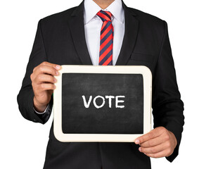 A Businessman holding slate mini blackboard with message Vote