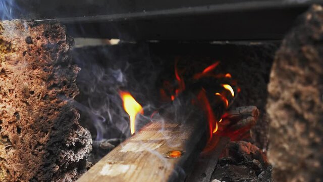 Bonfire. Flames. Pot of food on the fire. Wooden logs in a fire flame. Outdoor tourist lunch. Danger. Camping. Outdoor barbecue. Campfire in the evening.