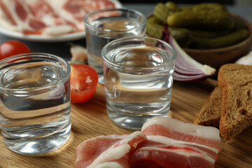 Shots of vodka and tasty snacks, close up