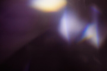Blur colorful warm rainbow light leaks on black background with dust texture. Defocused abstract...