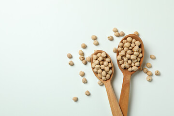 Spoons with fresh chickpea on white background