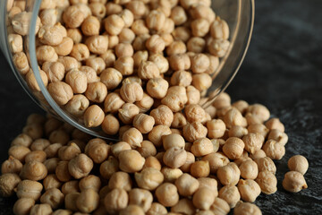 Glass jar with chickpea on black smokey table