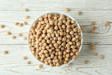 Bowl with chickpea on white wooden table