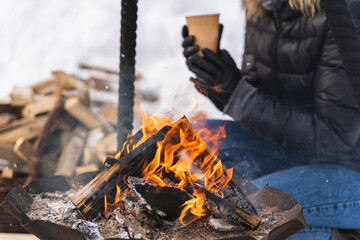 Firewood burning inside the fire-pit during cold winter day