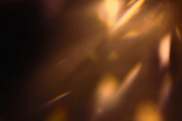 Blur colorful warm rainbow light leaks on black background with dust texture. Defocused abstract...