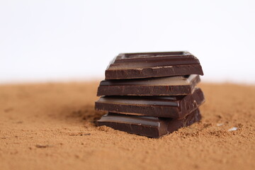 Chocolate bar pieces lie a stack of slides on each other day chocolate kind of side with space for text and copyspace