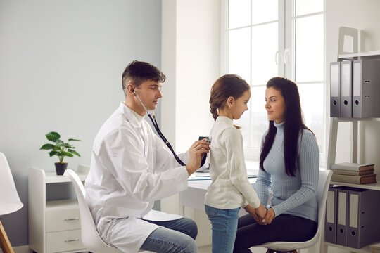 Mother and child seeing family doctor. General practitioner or pediatrician with stethoscope listening to little patient's lungs. Health screening, regular check up, respiratory diseases prevention