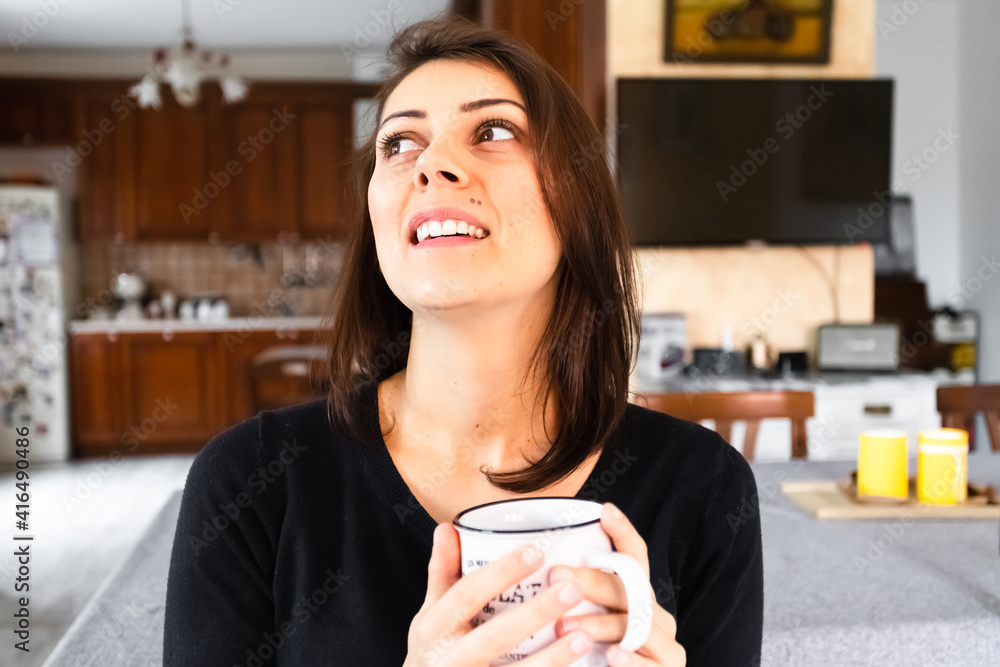 Wall mural beautiful caucasian girl smiling holding a cup of coffee. carefree life