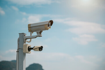 Modern CCTV security system on sky background Smart camera theft protection.