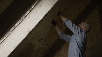 Handyman putting insolation in a wall