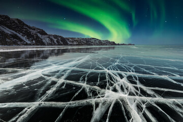 Aurora borealis over frozen lake Baikal in winter
