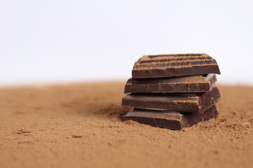 Chocolate bar pieces lie a stack of slides on each other day chocolate kind of side with space for text and copyspace