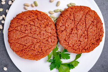 Tasty uncooked burger made with vegetarian plant based imitation minced meat ready for grill