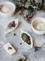 herbal cosmetics, cream and powder, natural ingredients. samples of cosmetics on a gray background