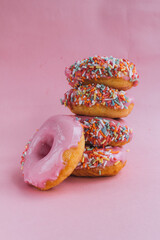 vegan pink donuts over pink background