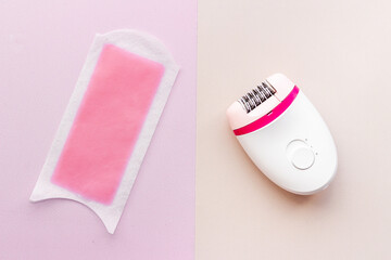 Epilator with pink wax strips. Epilation concept. Top view, flat lay
