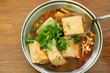 Eating stinky tofu hot pot with spicy soup.