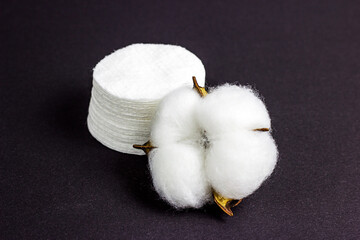 White soft cotton pads for hygiene and healthcare on black background.