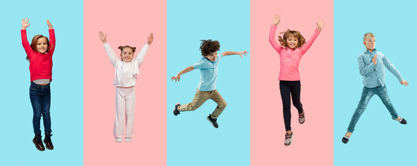 Group of elementary school kids or pupils jumping in colorful casual clothes on bicolored studio background. Creative collage. Back to school, education, childhood concept. Cheerful girls and boys.