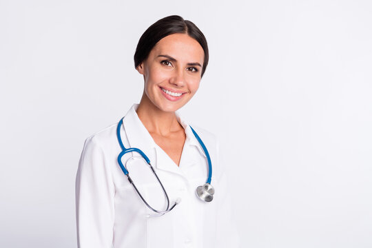 Photo of positive good mood young lady medic dressed uniform smiling empty space isolated white color background