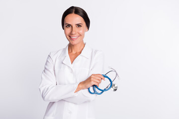 Photo of charming positive young woman therapist wear formal coat holding stethoscope empty space isolated white color background
