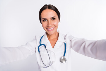 Photo of sweet adorable young woman doctor wear formal coat tacking selfie smiling isolated white...