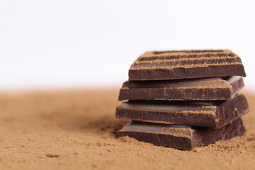 Chocolate bar pieces lie a stack of slides on each other day chocolate kind of side with space for text and copyspace