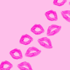 Creative pattern made with purple or violet kisses on pastel pink background. Retro style aesthetic. 80s, 90s Romantic concept with kiss print and lipstick. Makeup idea. Valentines day idea.