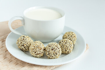 truffles with cocoa, coconut and sesame with chocolate and marshmallows and a cup of fresh milk, delicious dessert