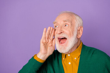 Photo of positive aged man arm near open mouth look interested empty space isolated on violet color background