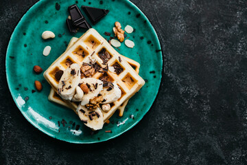 Sweet Belgian waffles with banana and chocolate and nuts